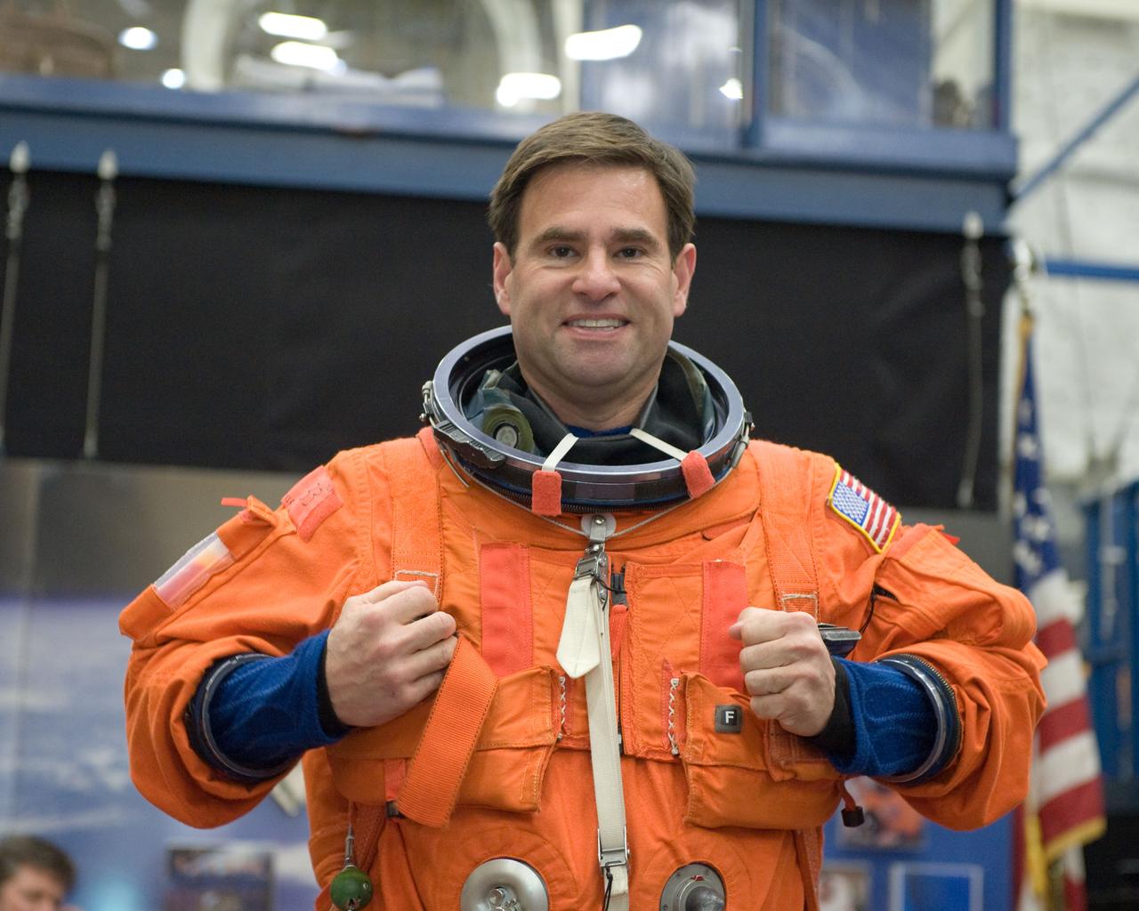 JSC2010-E-051958 (12 April 2010) --- NASA astronaut Greg Chamitoff, STS-134 mission specialist, dons a training version of his shuttle launch and entry suit in preparation for a post insertion/de-orbit training session in the Space Vehicle Mock-up Facility at NASA's Johnson Space Center.