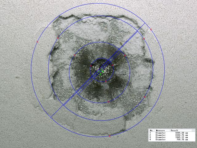 JSC2010-E-054443 (17 July 2009) --- Diameter measurements of an impact crater on the Hubble Space Telescope Wide Field and Planetary Camera (WFPC-2), returned to Earth in May 2009, following the STS-125 mission.  Photo credit: NASA or National Aeronautics and Space Administration
