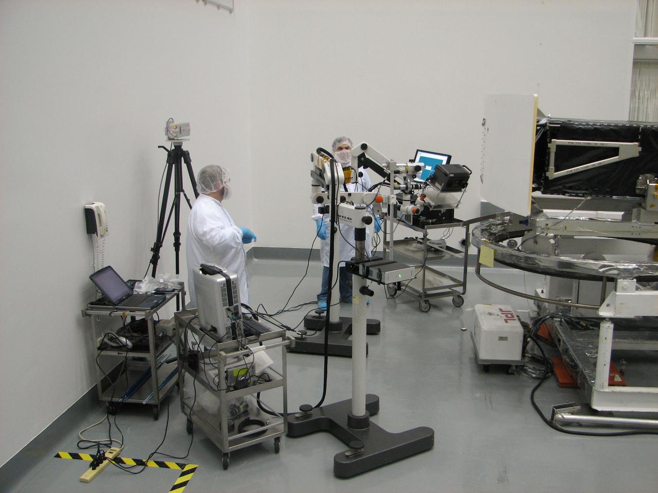 JSC2010-E-054445 (2 July 2009) --- Members of the Orbital Debris Program Office and the Hypervelocity Impact Technology Facility at JSC record images of impact craters and other surface data on the returned Wide Field and Planetary Camera (WFPC-2) of the Hubble Space Telescope.  Inspection took place at the Goddard Space Flight Center during the summer of 2009. Photo credit: NASA or National Aeronautics and Space Administration