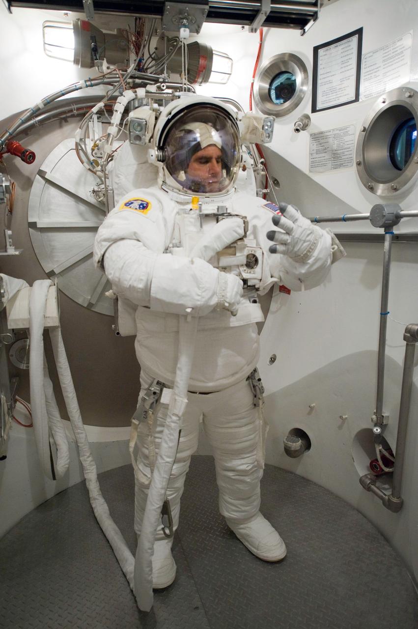 JSC2010-E-060730 (29 April 2010) --- NASA astronaut Greg Chamitoff, STS-134 mission specialist, participates in an Extravehicular Mobility Unit (EMU) spacesuit fit check in the Space Station Airlock Test Article (SSATA) in the Crew Systems Laboratory at NASA's Johnson Space Center.
