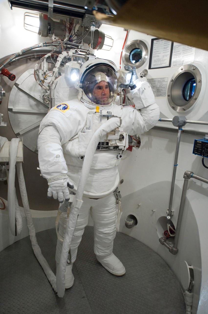JSC2010-E-060732 (29 April 2010) --- NASA astronaut Greg Chamitoff, STS-134 mission specialist, participates in an Extravehicular Mobility Unit (EMU) spacesuit fit check in the Space Station Airlock Test Article (SSATA) in the Crew Systems Laboratory at NASA's Johnson Space Center.