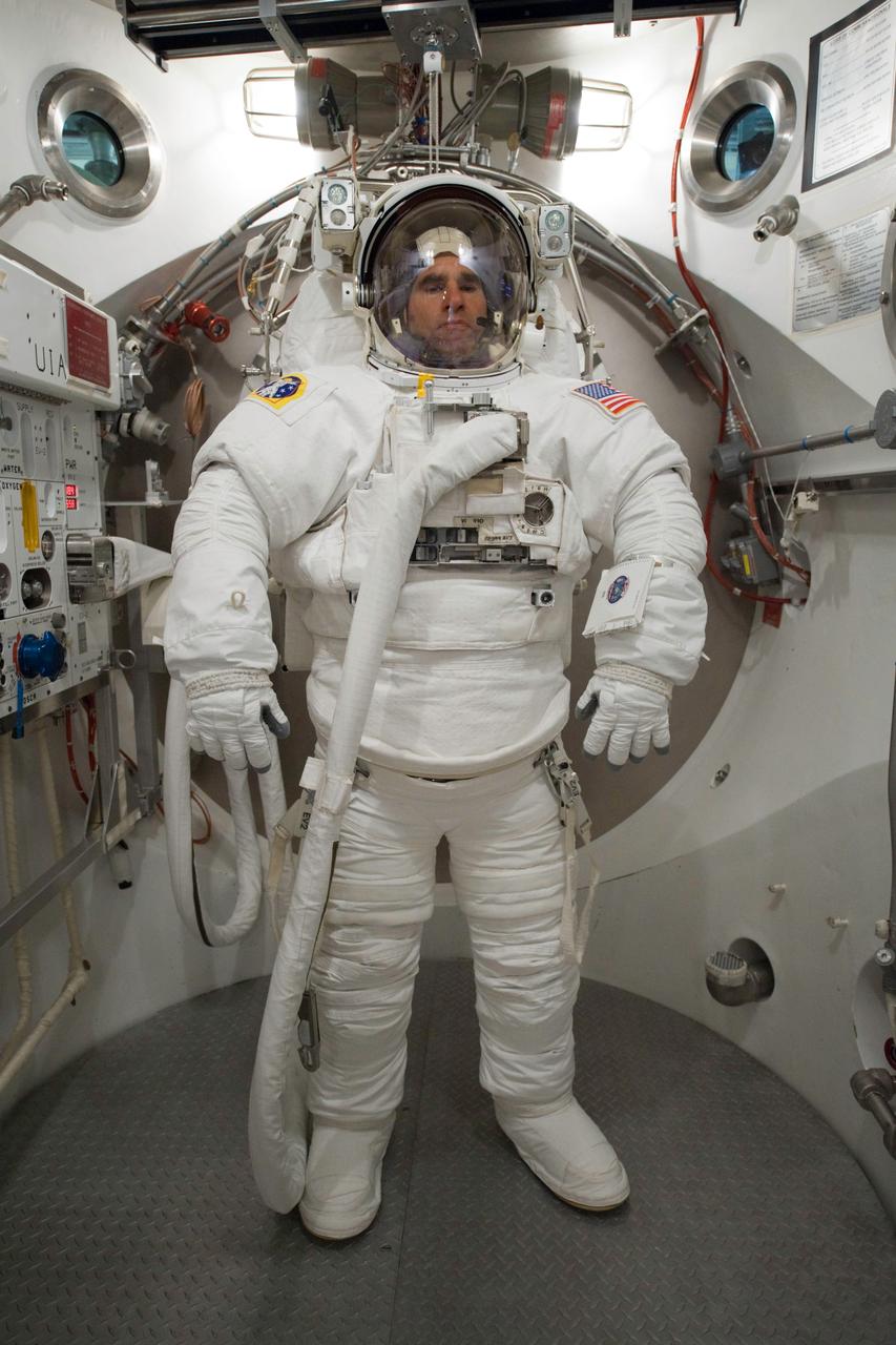 JSC2010-E-060735 (29 April 2010) --- NASA astronaut Greg Chamitoff, STS-134 mission specialist, participates in an Extravehicular Mobility Unit (EMU) spacesuit fit check in the Space Station Airlock Test Article (SSATA) in the Crew Systems Laboratory at NASA's Johnson Space Center.