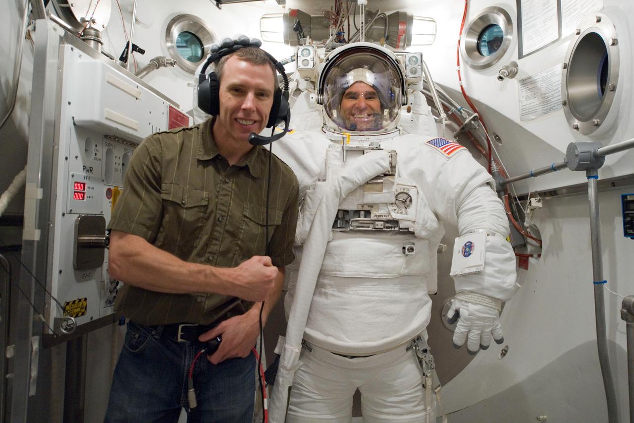 JSC2010-E-060738 (29 April 2010) --- NASA astronaut Greg Chamitoff, STS-134 mission specialist, participates in an Extravehicular Mobility Unit (EMU) spacesuit fit check in the Space Station Airlock Test Article (SSATA) in the Crew Systems Laboratory at NASA's Johnson Space Center. NASA astronaut Andrew Feustel, mission specialist, assisted Chamitoff.