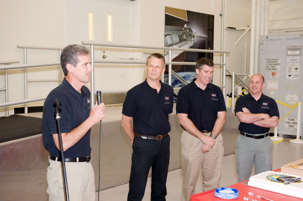 JSC2010-E-061462 (29 April 2010) --- NASA astronaut Mike Good, STS-132 mission specialist, speaks to a crowd during a cake-cutting ceremony in the Jake Garn Simulation and Training Facility at NASA's Johnson Space Center. Also pictured (from second left) are NASA astronauts Piers Sellers, Steve Bowen and Garrett Reisman, all mission specialists.