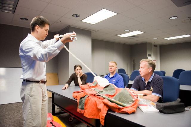 NASA image: STS-133 crew during water survival briefing in the classroom