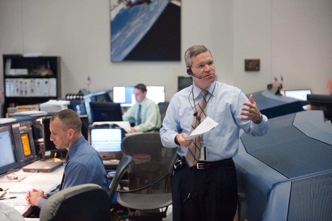 JSC2010-E-080410 (14 May 2010) --- Astronauts Steve Frick (standing) and Charles Hobaugh, both spacecraft communicators (CAPCOM) for the STS-132 mission, are pictured in the space shuttle flight control room in the Johnson Space Center's Mission Control Center during launch countdown activities a few hundred miles away in Florida, site of space shuttle Atlantis? STS-132 launch. Liftoff was on time at 2:20 p.m. (EDT) on May 14, 2010 from launch pad 39A at NASA's Kennedy Space Center.