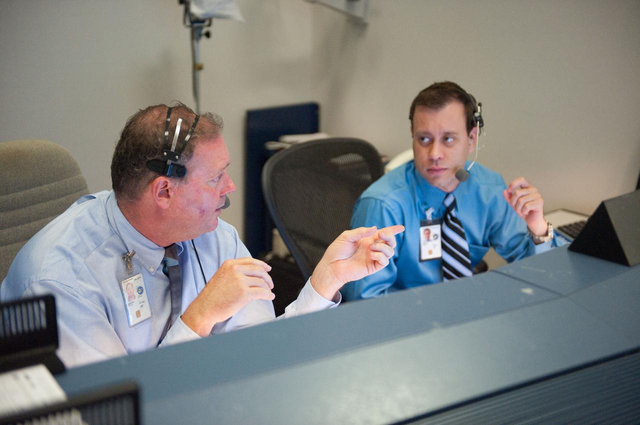 JSC2010-E-080436 (14 May 2010) --- Kyle Herring (left) and Joshua Byerly, both Public Affairs Office (PAO) commentators, are pictured at their console in the space shuttle flight control room in the Mission Control Center at NASA's Johnson Space Center during launch countdown activities a few hundred miles away in Florida, site of space shuttle Atlantis? STS-132 launch. Liftoff was on time at 2:20 p.m. (EDT) on May 14, 2010 from launch pad 39A at NASA's Kennedy Space Center.