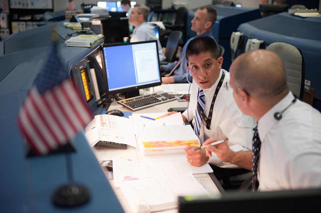 JSC2010-E-080439 (14 May 2010) --- Flight directors Richard Jones and Tony Ceccacci (foreground) monitor data at their console in the space shuttle flight control room in the Mission Control Center at NASA's Johnson Space Center during launch countdown activities a few hundred miles away in Florida, site of space shuttle Atlantis? STS-132 launch. Liftoff was on time at 2:20 p.m. (EDT) on May 14, 2010 from launch pad 39A at NASA's Kennedy Space Center.