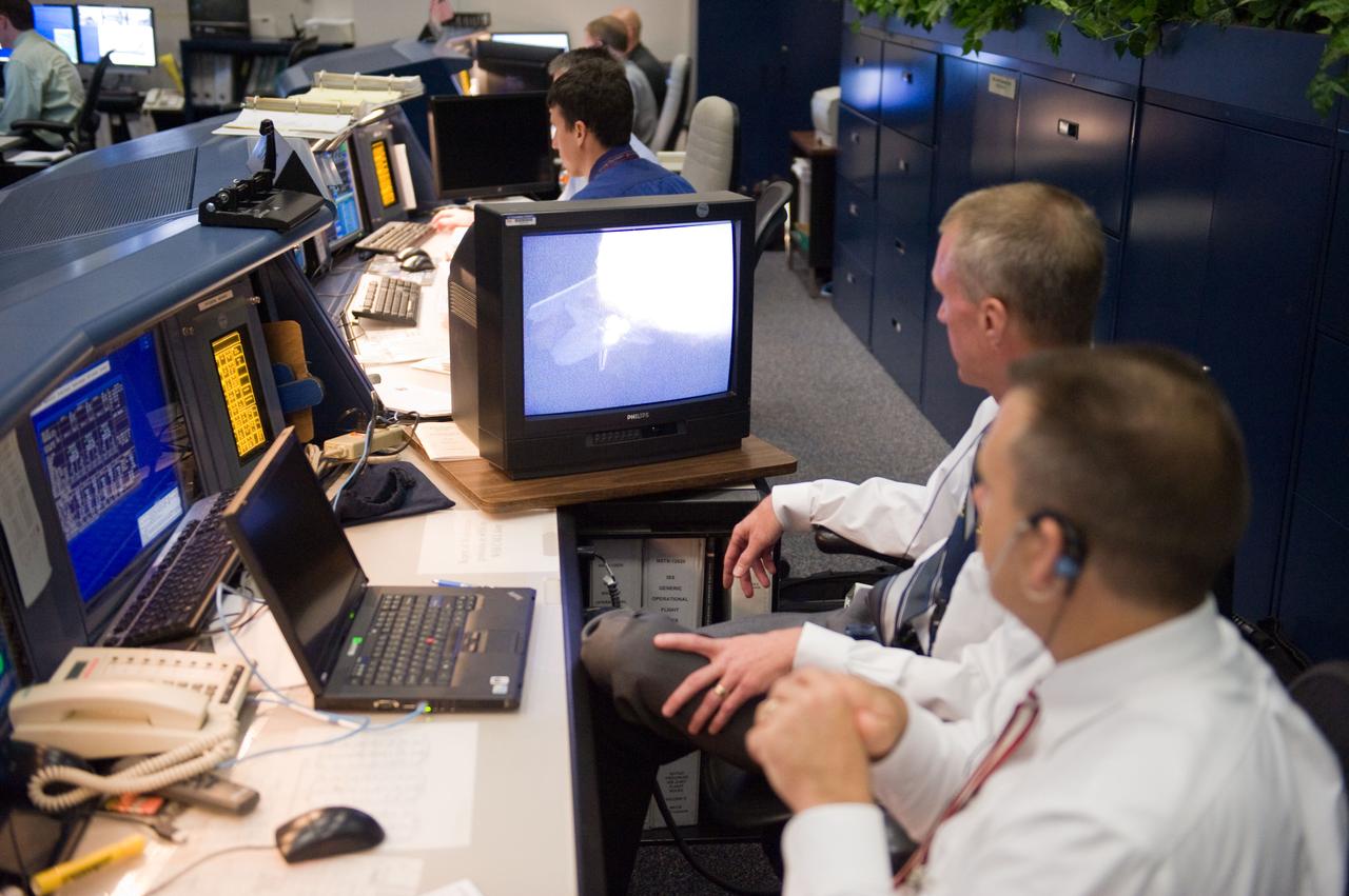 JSC2010-E-080460 (14 May 2010) --- Brent Jett, director, flight crew operations; and flight director Norm Knight (foreground) watch a monitor in the space shuttle flight control room in the Mission Control Center at NASA's Johnson Space Center during the launch of space shuttle Atlantis a few hundred miles away in Florida. Liftoff was on time at 2:20 p.m. (EDT) on May 14, 2010 from launch pad 39A at NASA's Kennedy Space Center.