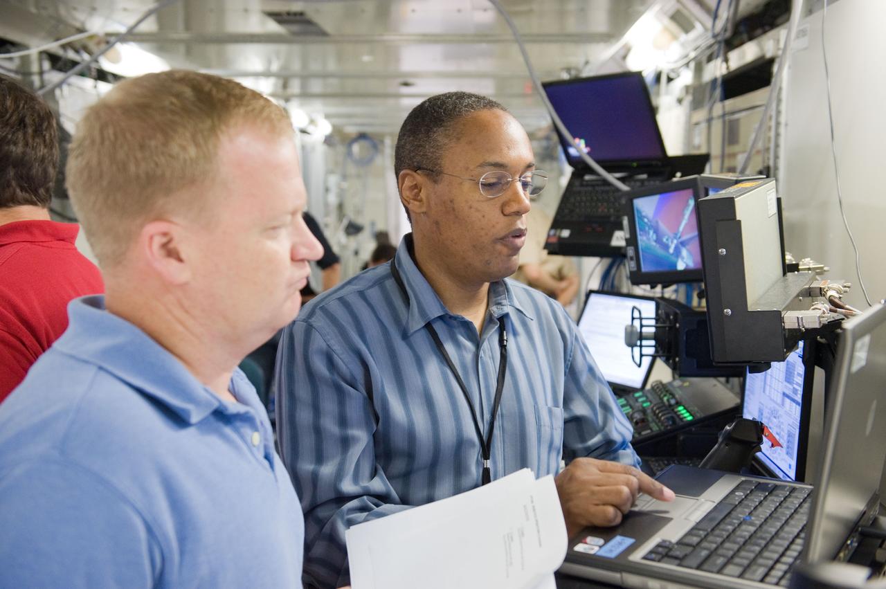 JSC2010-E-084025 (18 May 2010) --- NASA astronauts Eric Boe (foreground), STS-133 pilot; and Alvin Drew, mission specialist, participate in a robotics training session in the Jake Garn Simulation and Training Facility at NASA's Johnson Space Center.