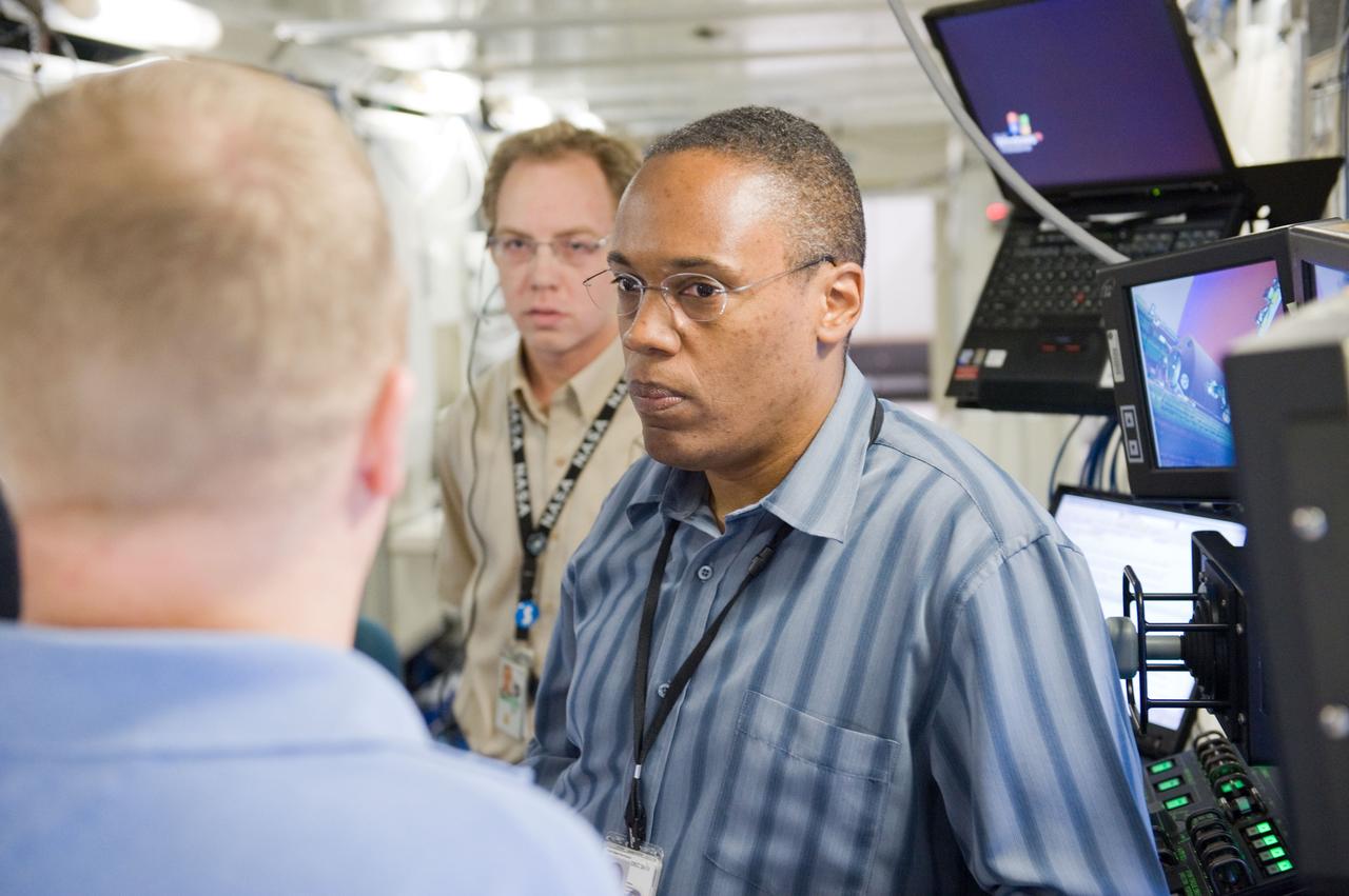 JSC2010-E-084026 (18 May 2010) --- NASA astronauts Alvin Drew, STS-133 mission specialist; and Eric Boe (back to camera), pilot, are pictured during a robotics training session in the Jake Garn Simulation and Training Facility at NASA's Johnson Space Center.