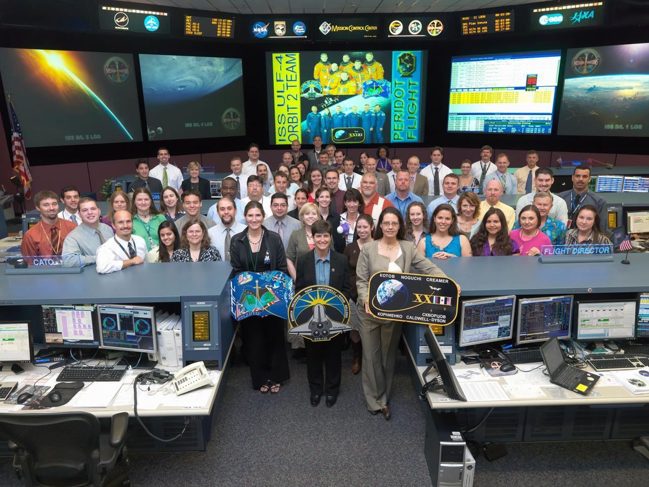 JSC2010-E-085365 (20 May 2010) --- The members of the STS-132/ULF-4 ISS Orbit 2 flight control team pose for a group portrait in the space station flight control room in the Mission Control Center at NASA's Johnson Space Center. Flight director Emily Nelson holds the Expedition 23 mission logo.