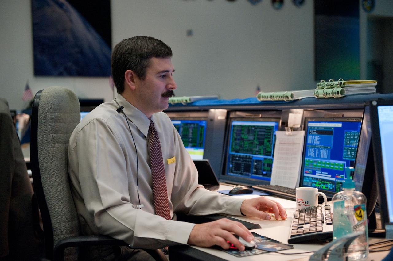 JSC2010-E-086375 (20 May 2010) --- Flight director Mike Sarafin monitors data at his console in the space shuttle flight control room in the Mission Control Center at NASA's Johnson Space Center during STS-132 mission flight day seven activities.