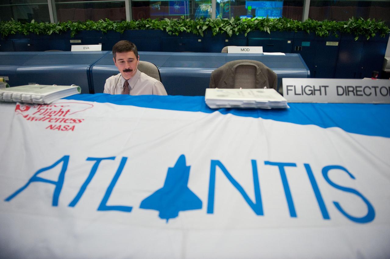 JSC2010-E-086399 (20 May 2010) --- Flight director Mike Sarafin monitors data at his console in the space shuttle flight control room in the Mission Control Center at NASA's Johnson Space Center during STS-132 mission flight day seven activities.