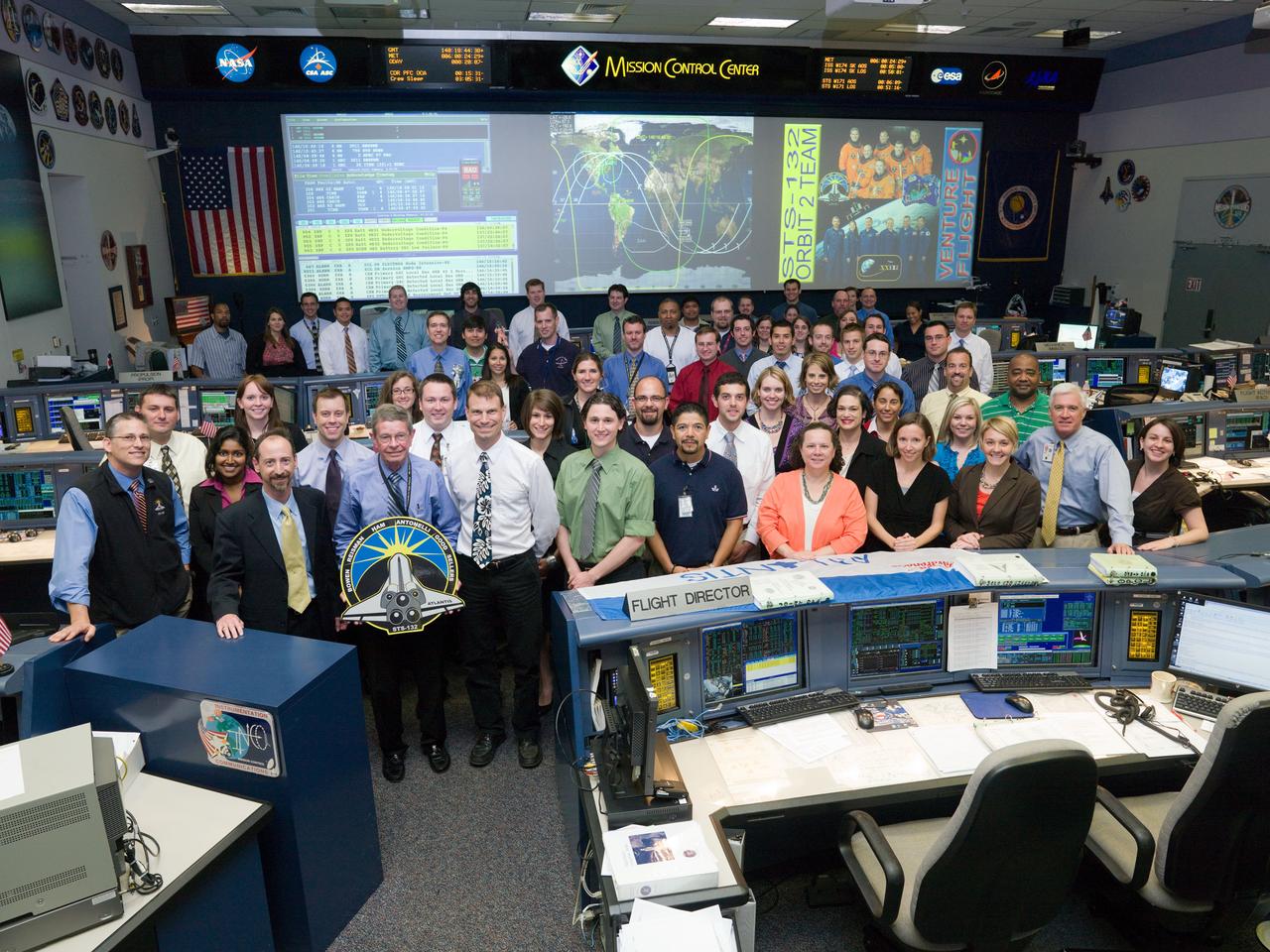 JSC2010-E-086451 (20 May 2010) --- The members of the STS-132 Orbit 2 flight control team pose for a group portrait in the space shuttle flight control room in the Mission Control Center at NASA's Johnson Space Center. Flight director Chris Edelen (second left) is visible on the front row.