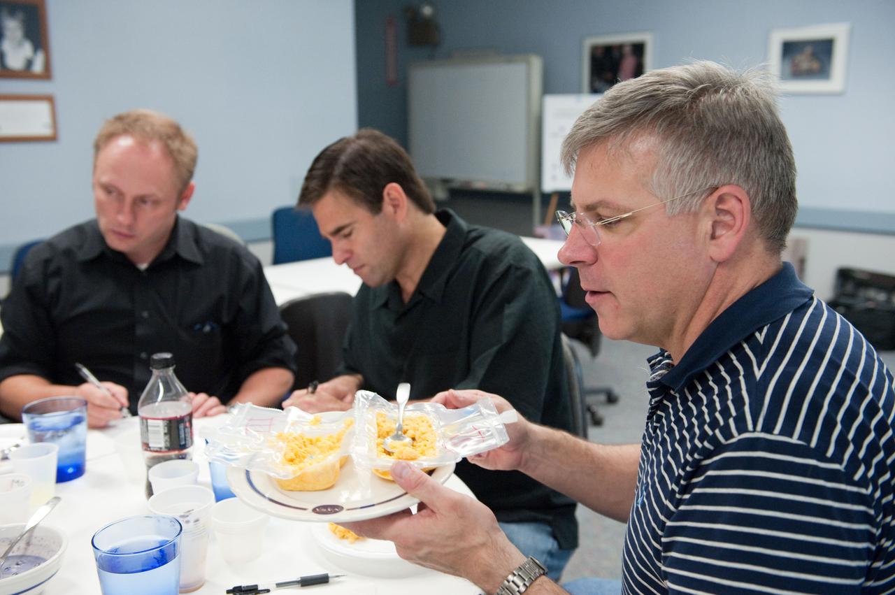 JSC2010-E-087708 (25 May 2010) --- NASA astronaut Gregory H. Johnson (foreground), STS-134 pilot; along with astronauts Greg Chamitoff and Michael Fincke, both STS-134 mission specialists, participate in a food tasting session in the Habitability and Environmental Factors Office at NASA's Johnson Space Center. Photo credit: NASA or National Aeronautics and Space Administration