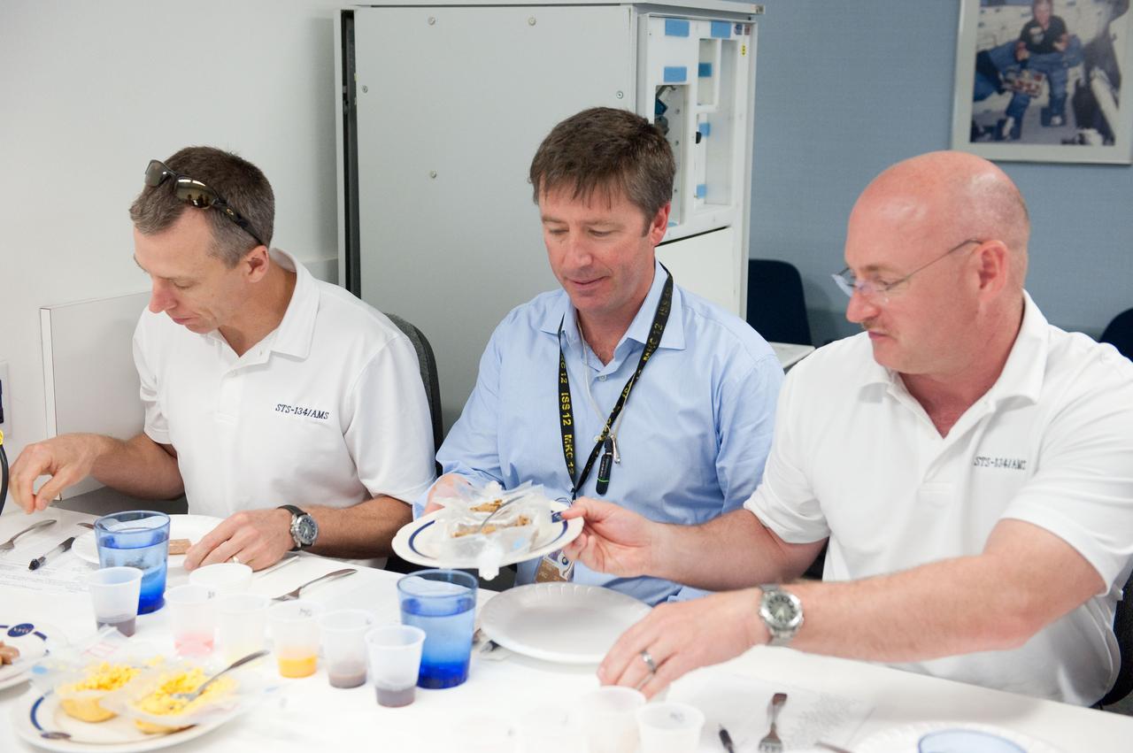 JSC2010-E-087709 (25 May 2010) --- NASA astronaut Mark Kelly (right), STS-134 commander; along with European Space Agency astronaut Roberto Vittori (center) and NASA astronaut Andrew Feustel, both mission specialists, participate in a food tasting session in the Habitability and Environmental Factors Office at NASA's Johnson Space Center. Photo credit: NASA or National Aeronautics and Space Administration
