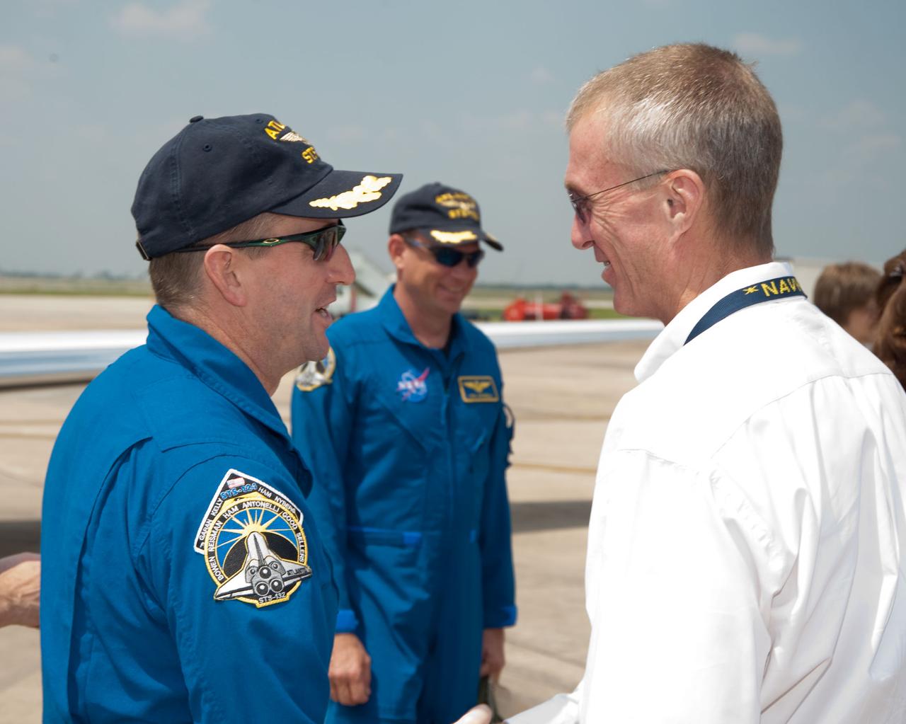 JSC2010-E-089667 (27 May 2010) --- Brent Jett (right), Johnson Space Center?s director of flight crew operations, greets NASA astronaut Ken Ham, STS-132 mission commander, shortly after he and five other crew members arrived at Ellington Field. NASA astronaut Tony Antonelli, pilot, is in the background. Awaiting them was a large crowd on hand in nearby Hangar 276 to welcome them home to Houston during a return ceremony for space shuttle Atlantis' final scheduled mission. Photo credit: NASA or National Aeronautics and Space Administration