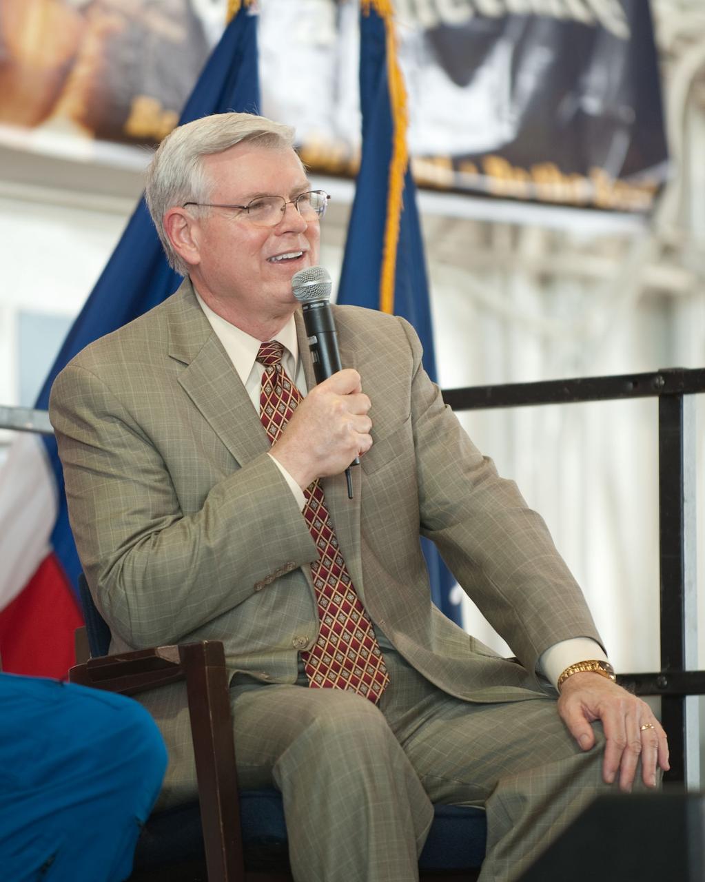 JSC2010-E-089680 (27 May 2010) ---  At Ellington Field's Hangar 276,  NASA's Johnson Space Center  director Michael L. Coats, speaks to a large crowd of visitors at the crew return ceremony for space shuttle Atlantis' final scheduled mission.  Each of the six crew members had a chance to express his sentiments to the visitors.  Photo credit: NASA or National Aeronautics and Space Administration