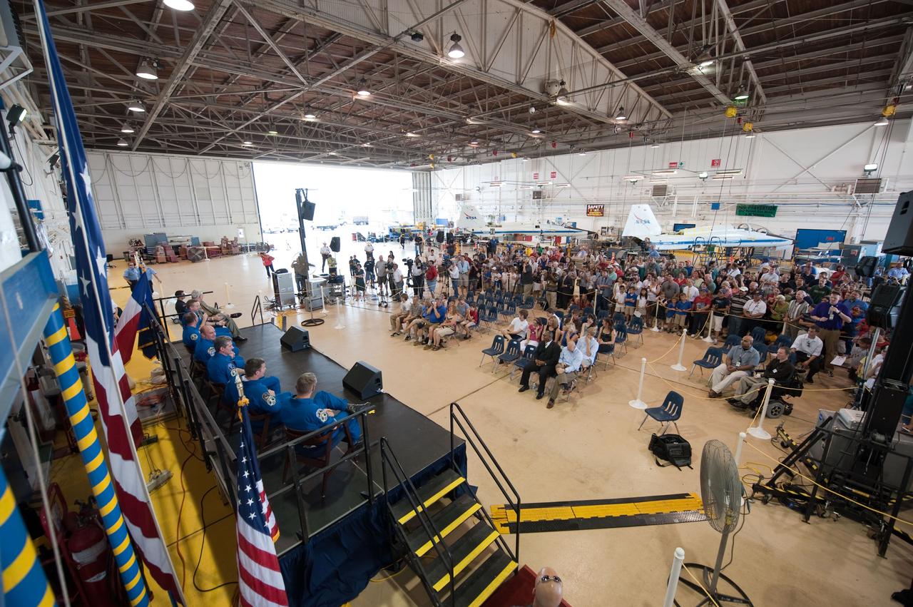 JSC2010-E-089686 (27 May 2010) ---  At Ellington Field's Hangar 276, a large crowd of visitors have gathered for the crew return ceremony for STS-132 -- space shuttle Atlantis' final scheduled mission. The crew is seated on the stage at left, along with NASA's Johnson Space Center (JSC) director Michael L. Coats.  . In the background is one of the T-38 trainers stationed at the air field, located just a few miles from the JSC main site. Photo credit: NASA or National Aeronautics and Space Administration