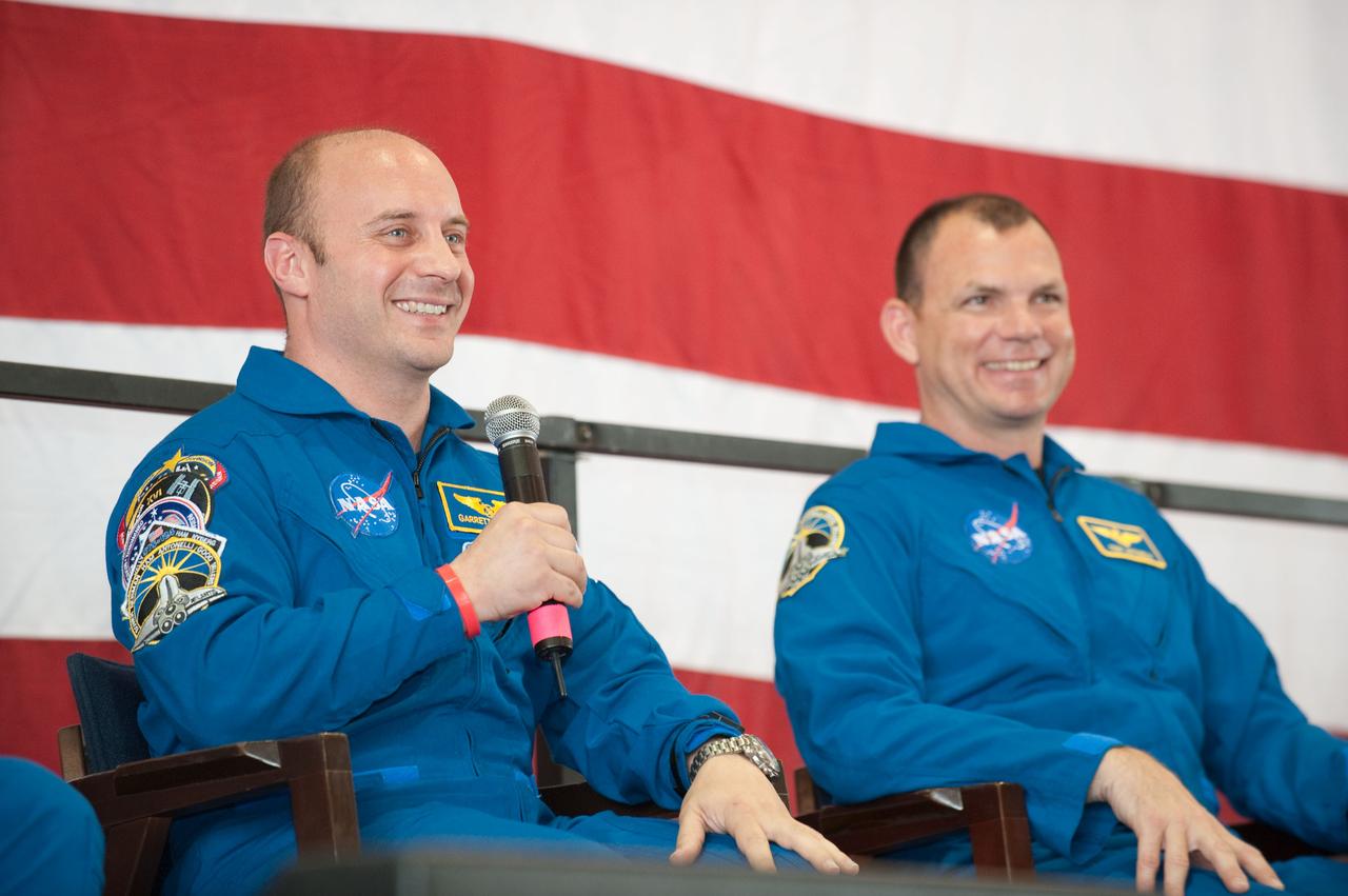JSC2010-E-089690 (27 May 2010) --- At Ellington Field's Hangar 276, NASA astronaut Garrett Reisman, STS-132 mission specialist, speaks to a large crowd of visitors at the crew return ceremony for space shuttle Atlantis' final scheduled mission. NASA astronaut Tony Antonelli (right), pilot, also had a chance to express his sentiments to the visitors, along with four other crew members (out of frame). Photo credit: NASA or National Aeronautics and Space Administration