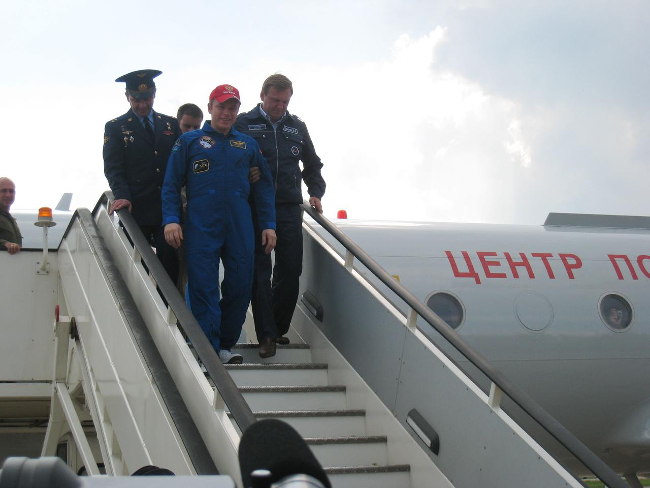 At Chkalovsky Airbase outside Star City, Russia, Expedition 23 Commander Oleg Kotov is assisted down the stairs of the plane that brought him home from Kazakhstan June 2, 2010 after he and Flight Engineers T.J. Creamer and Soichi Noguchi landed in the Soyuz TMA-17 spacecraft earlier in the day to wrap up 163 days in space. Kotov is flanked by Chief Cosmonaut Yuri Gidzenko (L) and Alexei Krasnov (R), the head of Piloted Programs for the Russian Federal Space Agency.  Credit:  NASA/Stephanie Stoll 