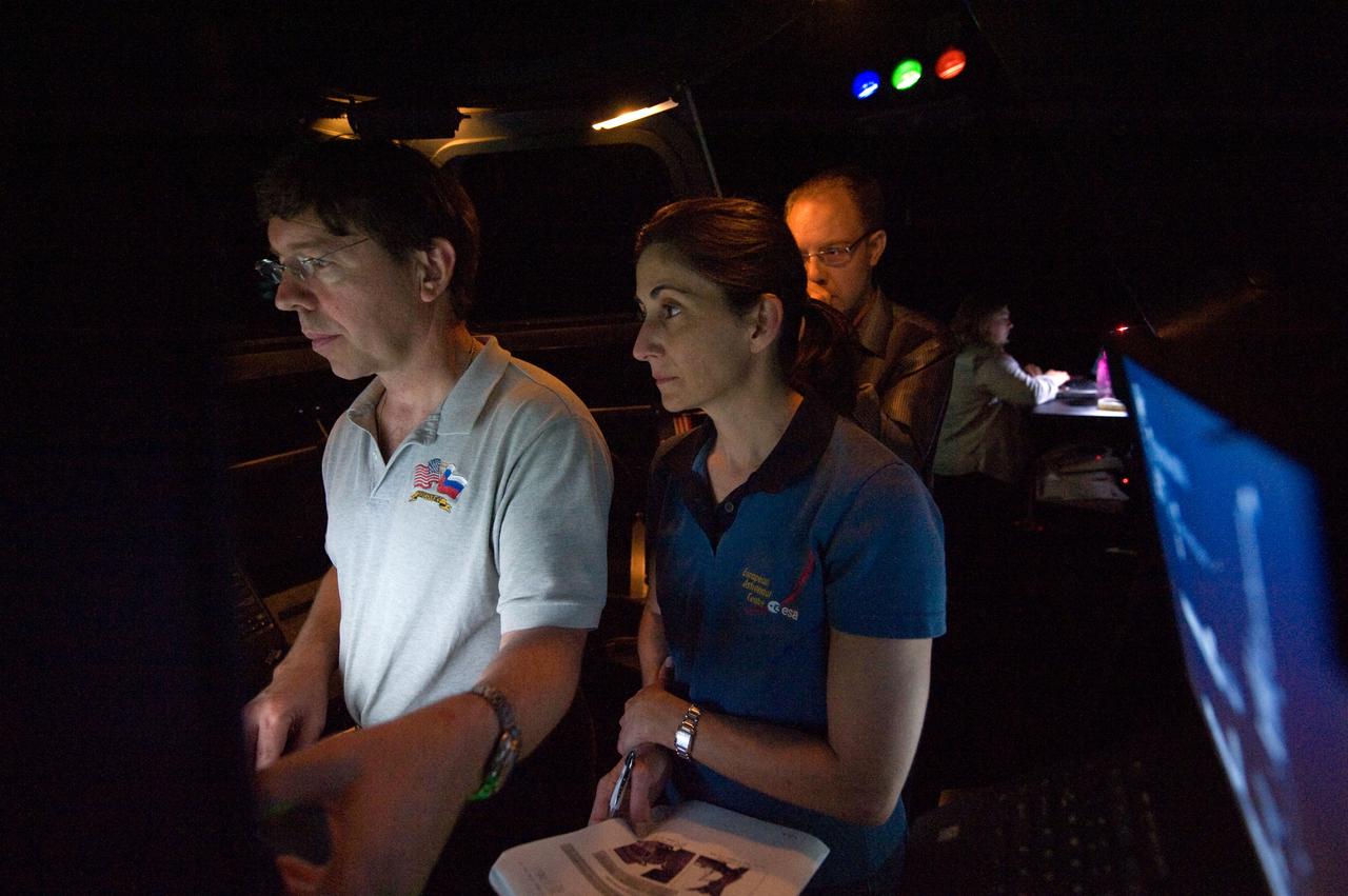 JSC2010-E-090700 (8 June 2010) --- NASA astronauts Michael Barratt and Nicole Stott, both STS-133 mission specialists, participate in an exercise in the systems engineering simulator in the Avionics Systems Laboratory at NASA's Johnson Space Center. The facility includes moving scenes of full-sized International Space Station components over a simulated Earth.