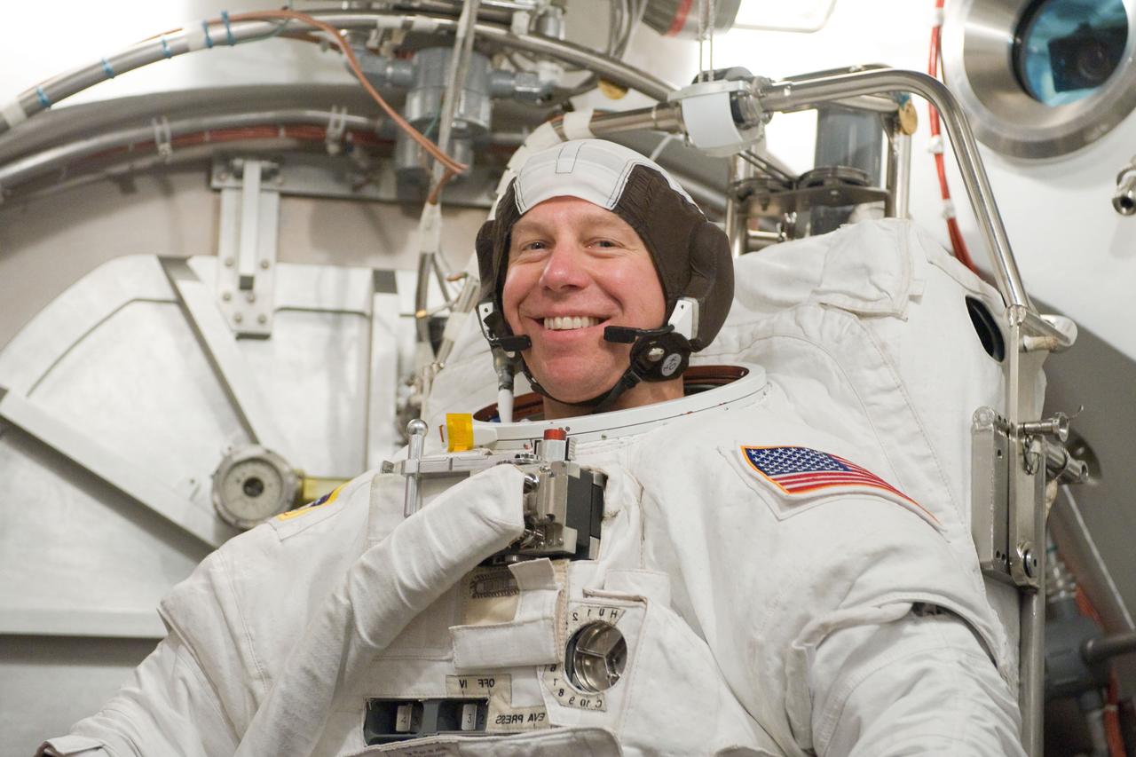 JSC2010-E-098596 (22 June 2010) --- NASA astronaut Tim Kopra, STS-133 mission specialist, participates in an Extravehicular Mobility Unit (EMU) spacesuit fit check in the Space Station Airlock Test Article (SSATA) in the Crew Systems Laboratory at NASA's Johnson Space Center.