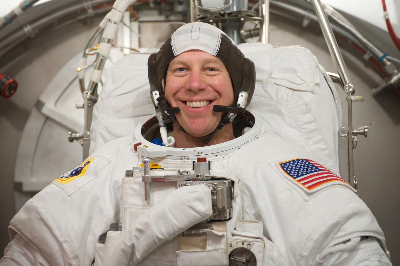 JSC2010-E-098597 (22 June 2010) --- NASA astronaut Tim Kopra, STS-133 mission specialist, participates in an Extravehicular Mobility Unit (EMU) spacesuit fit check in the Space Station Airlock Test Article (SSATA) in the Crew Systems Laboratory at NASA's Johnson Space Center.