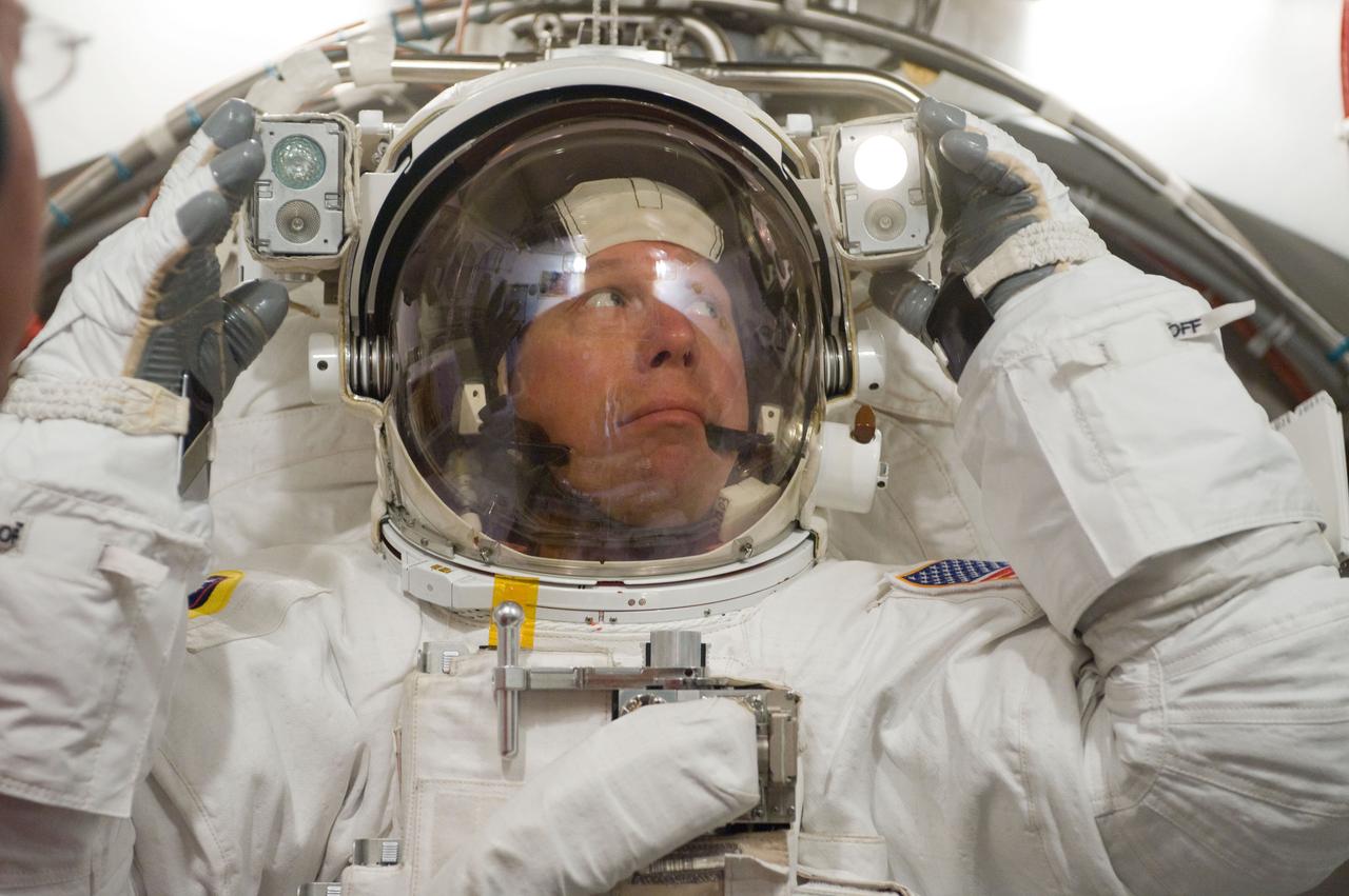 JSC2010-E-098613 (22 June 2010) --- NASA astronaut Tim Kopra, STS-133 mission specialist, participates in an Extravehicular Mobility Unit (EMU) spacesuit fit check in the Space Station Airlock Test Article (SSATA) in the Crew Systems Laboratory at NASA's Johnson Space Center.