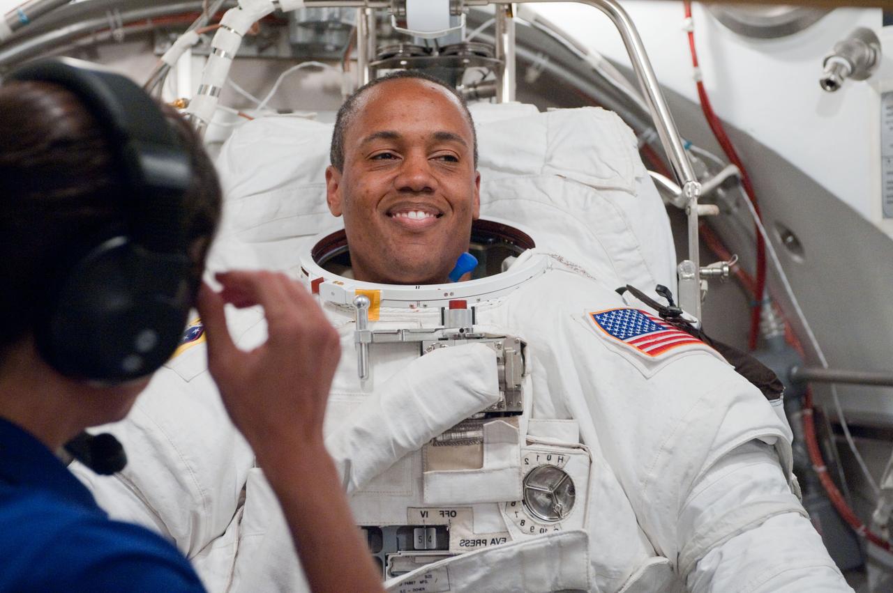 JSC2010-E-101111 (24 June 2010) --- NASA astronaut Alvin Drew, STS-133 mission specialist, participates in an Extravehicular Mobility Unit (EMU) spacesuit fit check in the Space Station Airlock Test Article (SSATA) in the Crew Systems Laboratory at NASA's Johnson Space Center. Photo credit: NASA or National Aeronautics and Space Administration