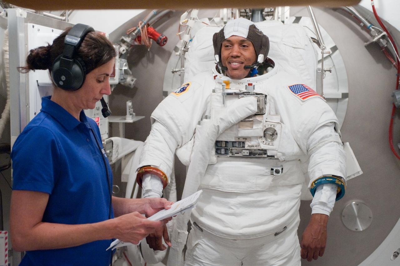 JSC2010-E-101115 (24 June 2010) --- NASA astronaut Alvin Drew, STS-133 mission specialist, participates in an Extravehicular Mobility Unit (EMU) spacesuit fit check in the Space Station Airlock Test Article (SSATA) in the Crew Systems Laboratory at NASA's Johnson Space Center. Astronaut Nicole Stott, mission specialist, assisted Drew. Photo credit: NASA or National Aeronautics and Space Administration