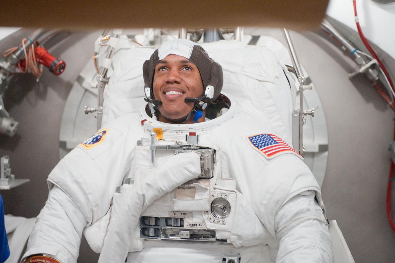 JSC2010-E-101116 (24 June 2010) --- NASA astronaut Alvin Drew, STS-133 mission specialist, participates in an Extravehicular Mobility Unit (EMU) spacesuit fit check in the Space Station Airlock Test Article (SSATA) in the Crew Systems Laboratory at NASA's Johnson Space Center. Photo credit: NASA or National Aeronautics and Space Administration