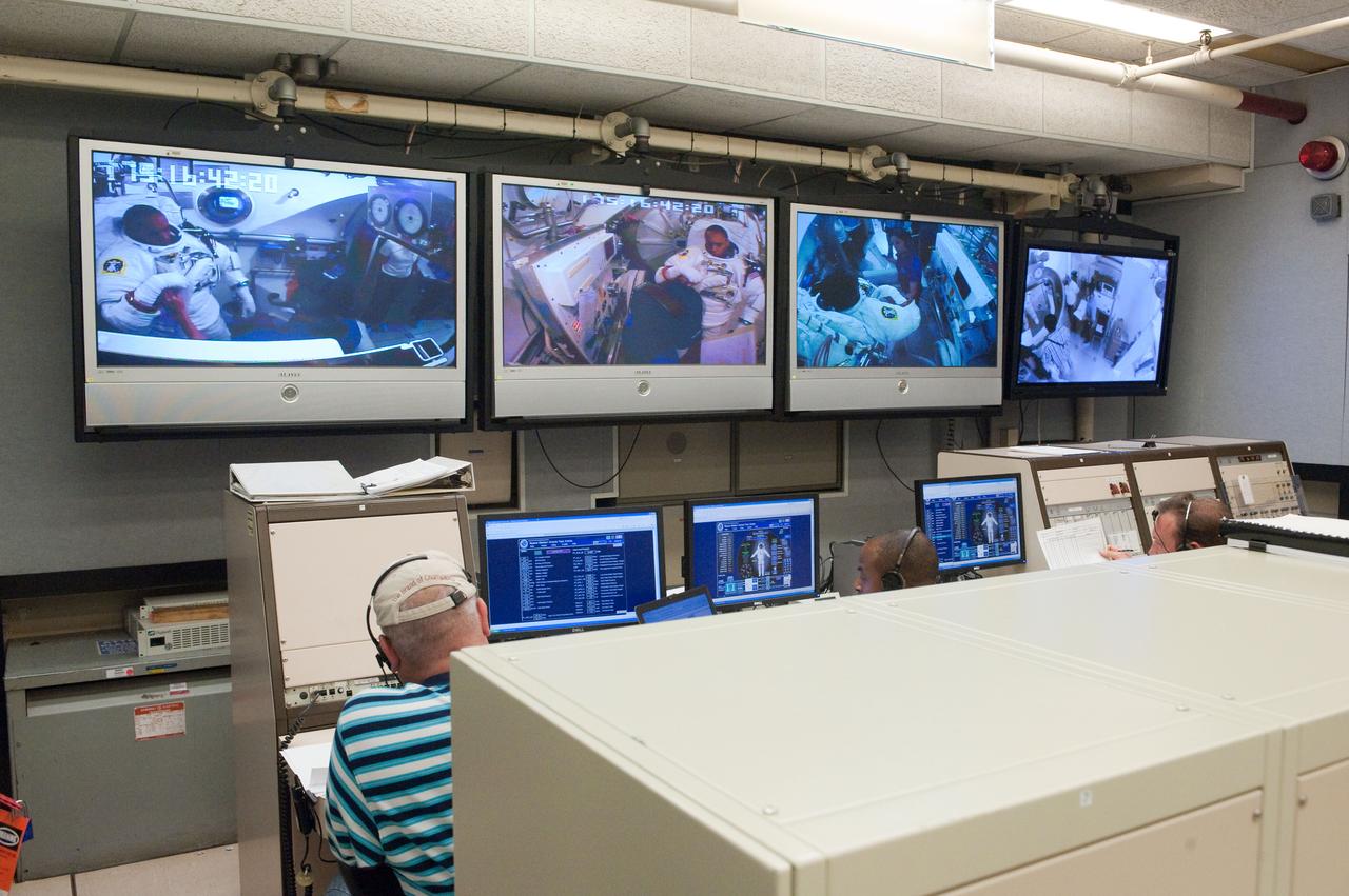 JSC2010-E-101137 (24 June 2010) --- NASA astronaut Alvin Drew, STS-133 mission specialist, is visible on the screens in the Space Station Airlock Test Article (SSATA) Control Room in the Crew Systems Laboratory at NASA?s Johnson Space Center during an Extravehicular Mobility Unit (EMU) spacesuit fit check. Photo credit: NASA or National Aeronautics and Space Administration
