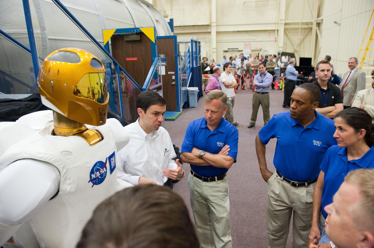 JSC2010-E-106311  (28 June 2010) --- NASA Robonaut Project Manager Ron Diftler (left) explains some of Robonaut 2?s features to members of the STS-133 crew ? continuing left, Steve Lindsey, commander; along with  Alvin Drew and Nicole Stott, both mission specialists;  and (bottom right corner)  Eric Boe, pilot. The STS-133 crew will deliver R2, as the robot is called, to the International Space Station on space shuttle Discovery?s final flight. Photo credit: NASA or National Aeronautics and Space Administration