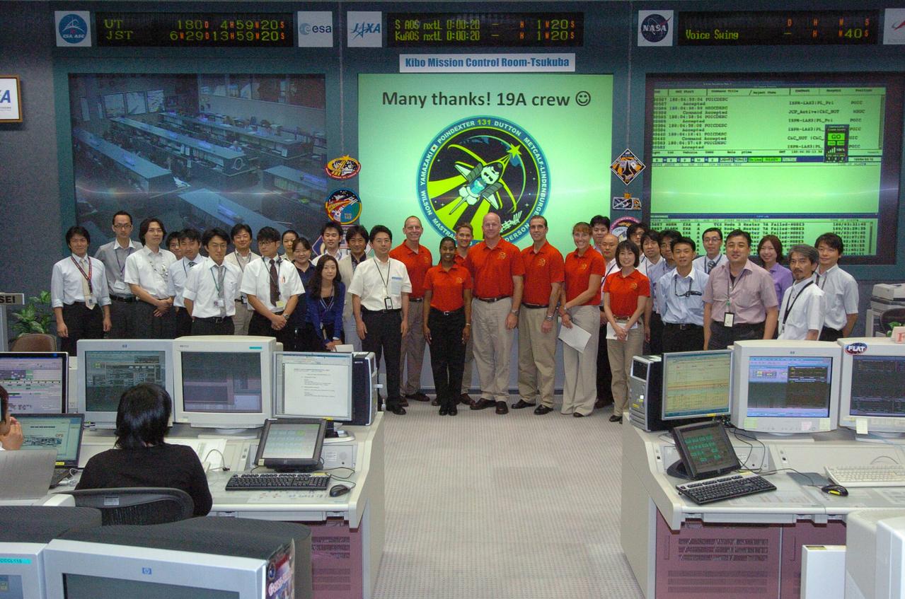 JSC2010-E-108817 (29 June 2010) --- The STS-131 crew is pictured with the support team at the Space Station Integration and Promotion Center in the Tsukuba Space Center on June 29 during one of its trips following the mission. Pictured in red shirts from the left are NASA astronauts  Clayton Anderson,   Stephanie Wilson, James P. Dutton Jr . Alan Poindexter,  Rick Mastracchio and  Dorothy Metcalf-Lindenburger, along with Japan Aerospace Exploration Agency (JAXA) astronaut Naoko Yamazaki.   Photo credit: Japan Aerospace Exploration Agency or JAXA
