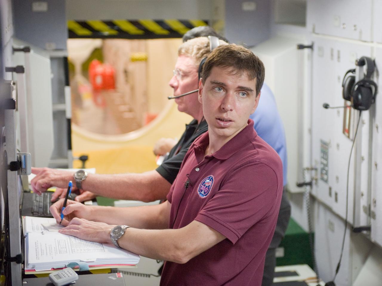 PHOTO DATE:  07-16-10 LOCATION: Bldg 9NW,  ISS Mockups SUBJECT:  28 crew member Mike Fossum, Satoshi Furukawa, Sergei Volkov during Emergency Scenario Assigned to training in ISS mockups PHOTOGRAPHER:  James Blair