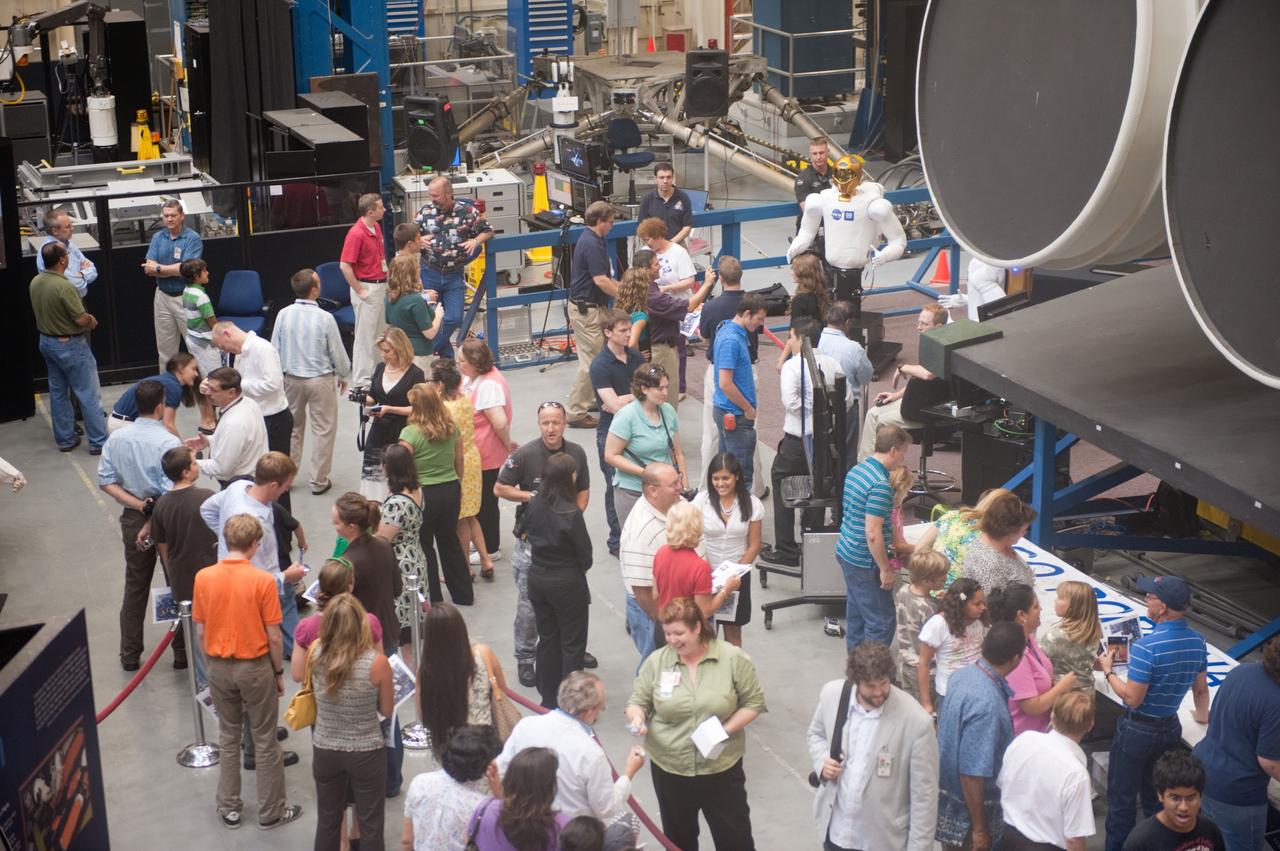 JSC2010-E-113084 (4 Aug. 2010) --- NASA personnel line up to see Robonaut 2 (R2) in the Space Vehicle Mock-up Facility at NASA's Johnson Space Center. R2, who will hitch a ride with the STS-133 crew members, is the first humanoid robot to travel to space and the first U.S.-built robot to visit the International Space Station. R2 will stay on the space station indefinitely to allow engineers on the ground to learn more about how humanoid robots fare in microgravity. Photo credit: NASA or National Aeronautics and Space Administration