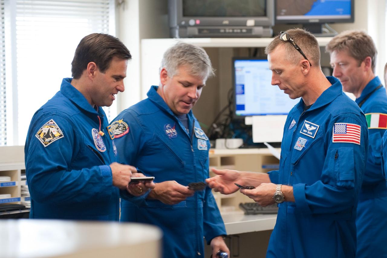 JSC2010-E-119534 (25 Aug. 2010) --- NASA astronaut Gregory H. Johnson (second left), STS-134 pilot; along with NASA astronauts Greg Chamitoff (left), Andrew Feustel and European Space Agency astronaut Roberto Vittori, all mission specialists, are pictured in the check-out facility at Ellington Field near NASA's Johnson Space Center prior to a familiarization flight in NASA T-38 trainer jets. Photo credit: NASA or National Aeronautics and Space Administration