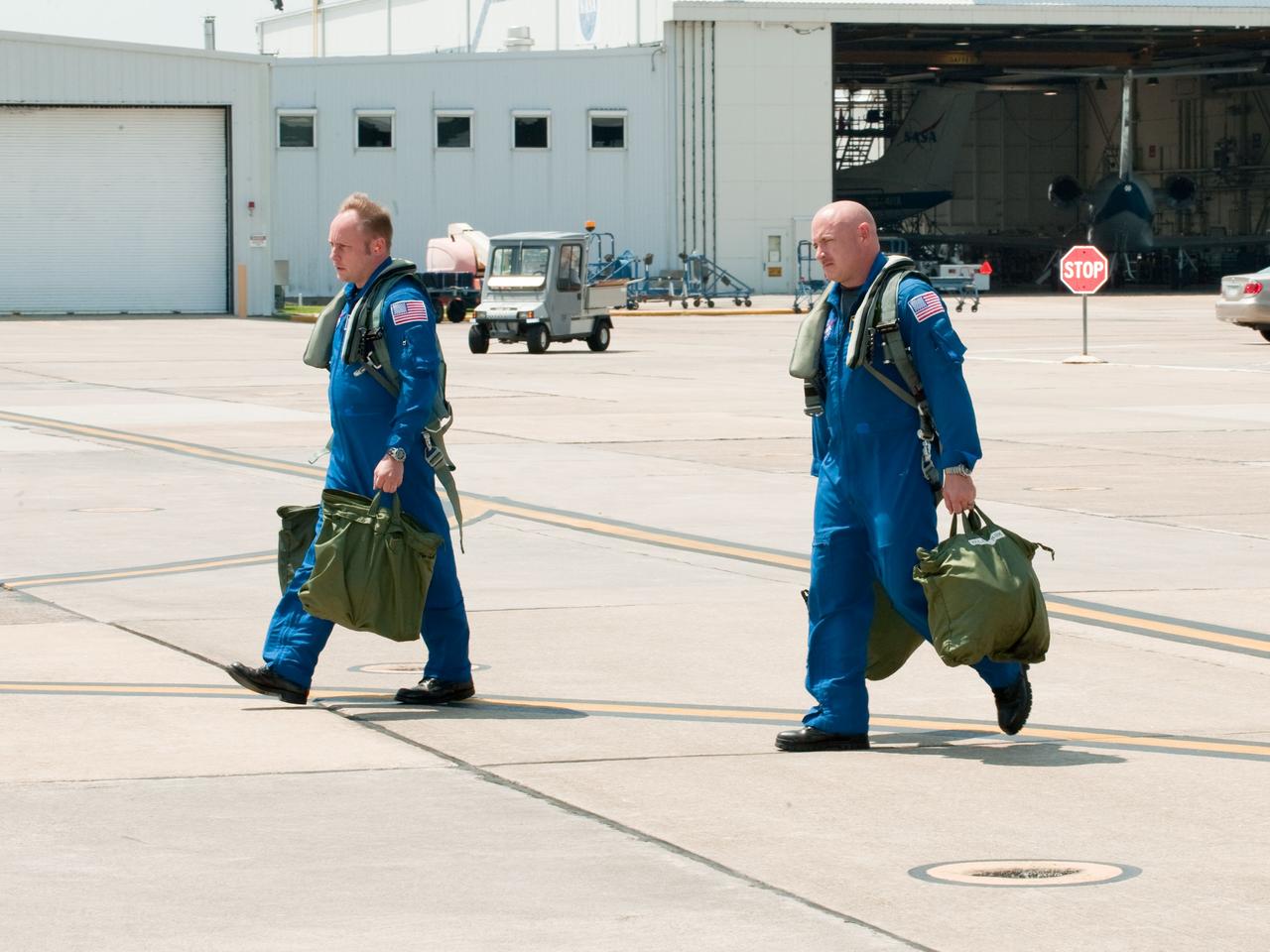 JSC2010-E-119538 (25 Aug. 2010) --- NASA astronauts Mark Kelly (right), STS-134 commander; and Michael Fincke, mission specialist, walk to the nearby flight line of NASA T-38 trainer jets at Ellington Field near NASA's Johnson Space Center prior to a familiarization flight. Photo credit: NASA or National Aeronautics and Space Administration