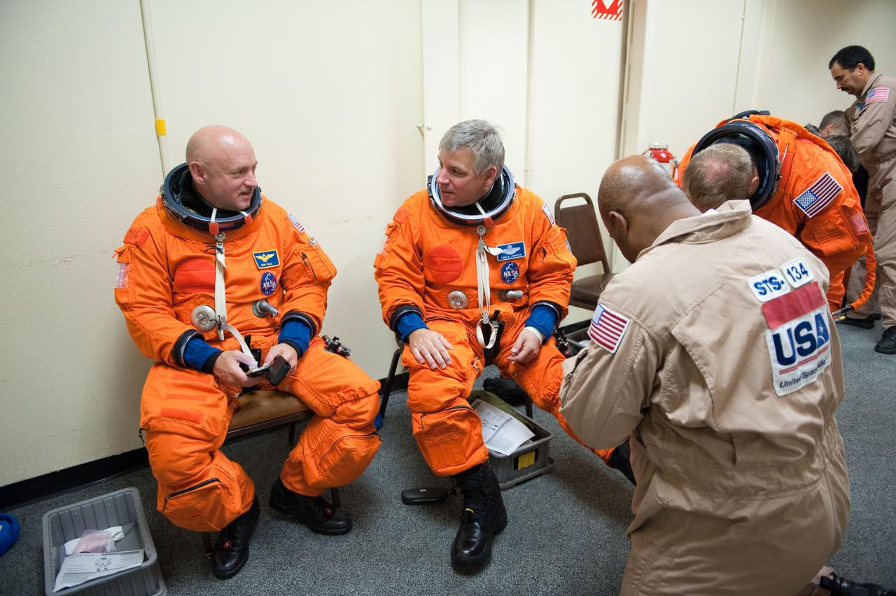 JSC2010-E-124267 (8 Sept. 2010) --- NASA astronauts Mark Kelly (left) and Gregory H. Johnson, STS-134 commander and pilot, respectively, attired in training versions of their shuttle launch and entry suits, prepare for a training session in the fixed-base shuttle mission simulator (SMS) in the Jake Garn Simulation and Training Facility at NASA?s Johnson Space Center. Photo credit: NASA or National Aeronautics and Space Administration
