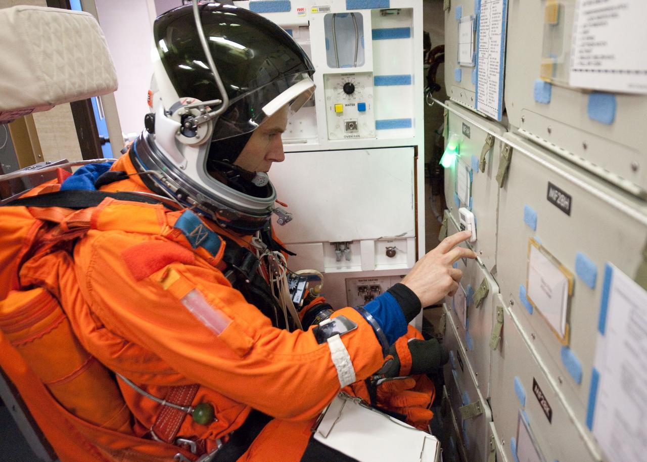 JSC2010-E-124284 (8 Sept. 2010) --- NASA astronaut Andrew Feustel, attired in a training version of his shuttle launch and entry suit, participates in a training session in the fixed-base shuttle mission simulator (SMS) in the Jake Garn Simulation and Training Facility at NASA?s Johnson Space Center. Photo credit: NASA or National Aeronautics and Space Administration