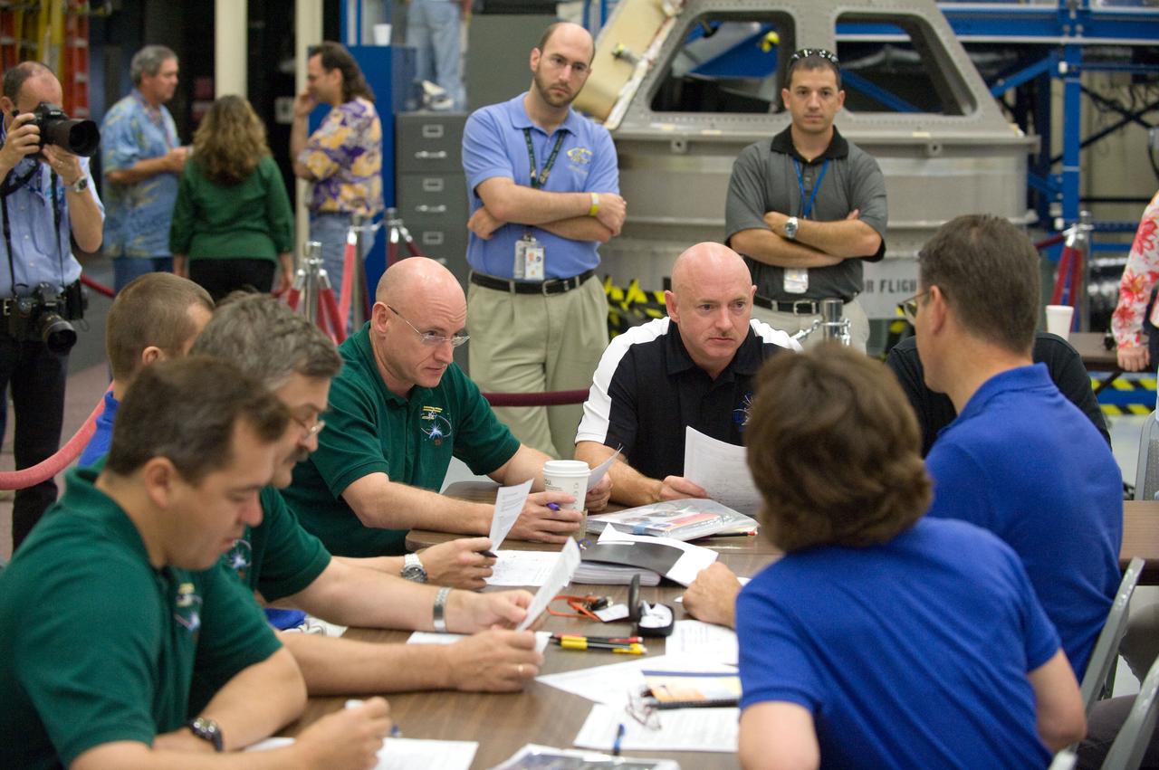JSC2010-E-132378 (16 July 2010) --- Pictured clockwise from the left, Russian cosmonauts Oleg Skripochka and Alexander Kaleri, both Expedition 25/26 flight engineers; Russian cosmonaut Dmitry Kondratyev, Expedition 26 flight engineer and Expedition 27 commander; NASA astronaut Scott Kelly, Expedition 25 flight engineer and Expedition 26 commander; NASA astronaut Mark Kelly, STS-134 commander; European Space Agency (ESA) astronaut Paolo Nespoli and NASA astronaut Catherine Coleman, both Expedition 26/27 flight engineers, participate in an emergency scenarios training session in the Space Vehicle Mock-up Facility at NASA's Johnson Space Center. Photo credit: NASA or National Aeronautics and Space Administration