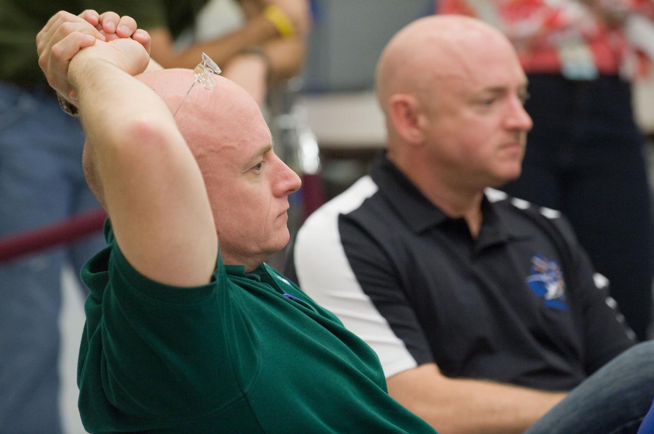 JSC2010-E-132379 (16 July 2010) --- NASA astronauts Scott Kelly (foreground), Expedition 25 flight engineer and Expedition 26 commander; and Mark Kelly, STS-134 commander, are pictured during an emergency scenarios training session in the Space Vehicle Mock-up Facility at NASA's Johnson Space Center. Photo credit: NASA or National Aeronautics and Space Administration