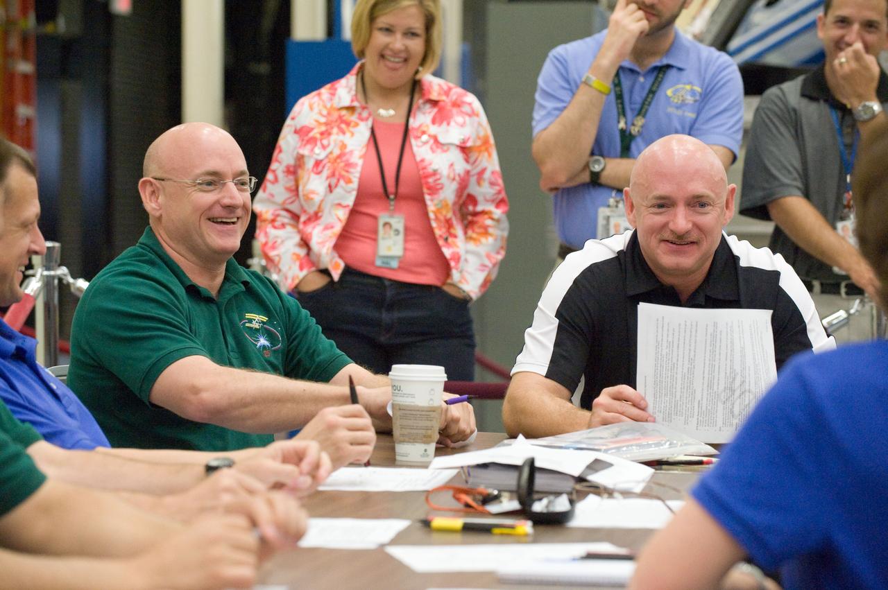 JSC2010-E-132381 (16 July 2010) --- NASA astronauts Scott Kelly (left), Expedition 25 flight engineer and Expedition 26 commander; and Mark Kelly, STS-134 commander, are pictured during an emergency scenarios training session in the Space Vehicle Mock-up Facility at NASA's Johnson Space Center.  Photo credit: NASA or National Aeronautics and Space Administration