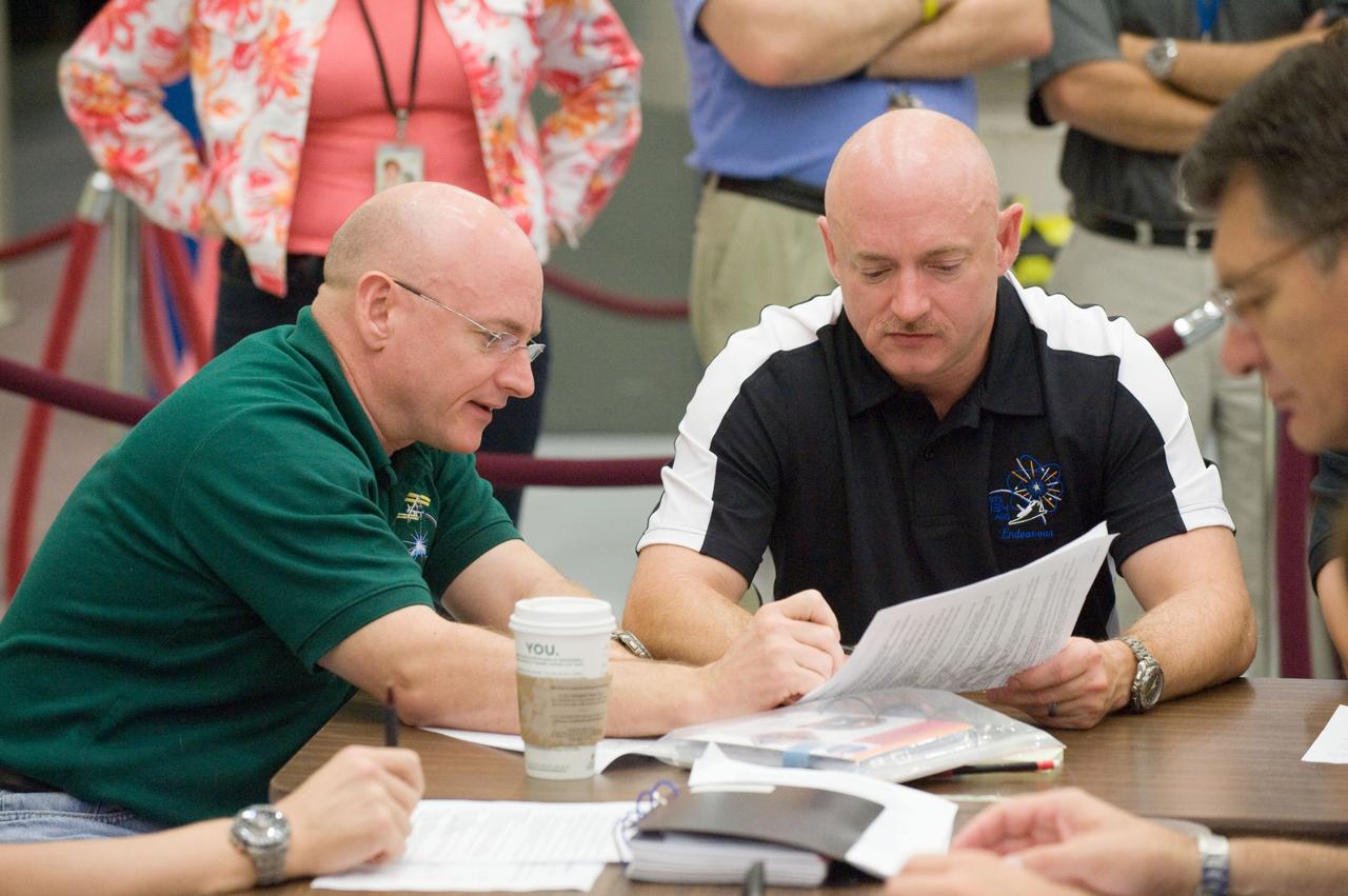 JSC2010-E-132382 (16 July 2010) --- NASA astronauts Scott Kelly (left), Expedition 25 flight engineer and Expedition 26 commander; and Mark Kelly, STS-134 commander, are pictured during an emergency scenarios training session in the Space Vehicle Mock-up Facility at NASA's Johnson Space Center.  Photo credit: NASA or National Aeronautics and Space Administration