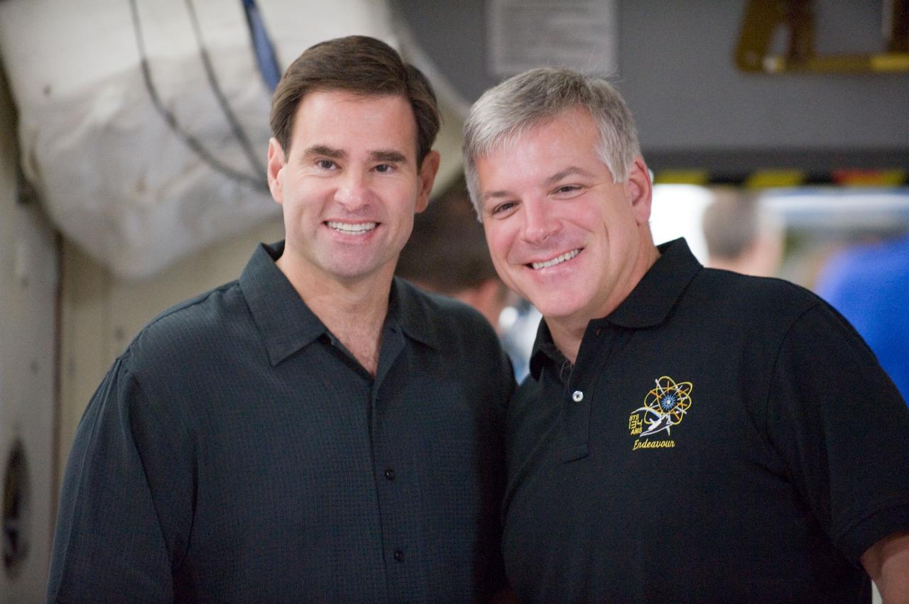 JSC2010-E-132399 (16 July 2010) --- NASA astronauts Greg Chamitoff (left), STS-134 mission specialist; and Gregory H. Johnson, pilot, pose for a photo during an emergency scenarios training session in the Space Vehicle Mockup Facility at NASA's Johnson Space Center. Photo credit: NASA or National Aeronautics and Space Administration
