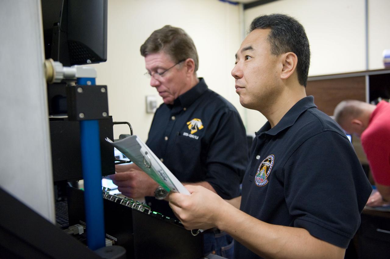 Expedition 28 JAXA Astronaut Satoshi Furukawa and Astronaut Mike Fossum during FF RNDZ ADV 4 training.  Training includes HTV rendezvous operation.  Photo Date: September 15, 2010.  Location: Building 30 - SIM City.  Photographer: Robert Markowitz.
