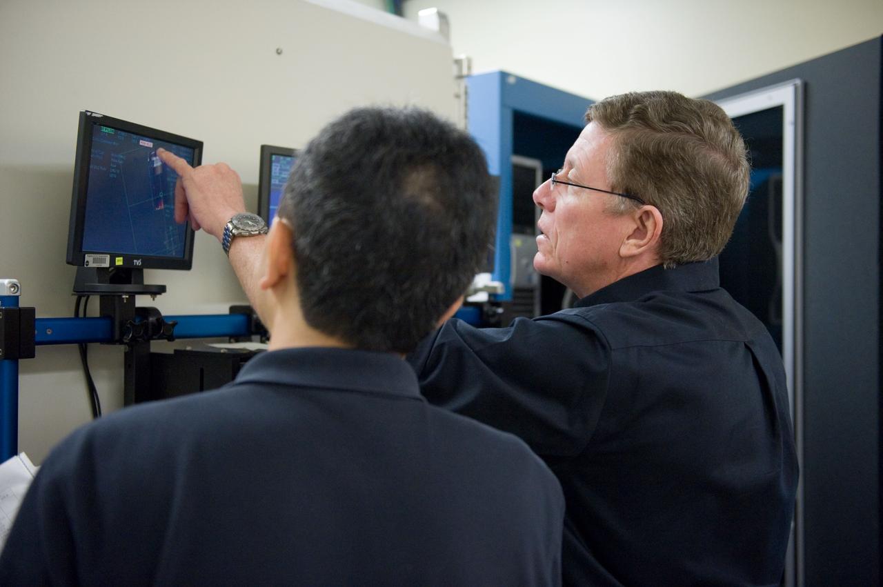 Expedition 28 JAXA Astronaut Satoshi Furukawa and Astronaut Mike Fossum during FF RNDZ ADV 4 training.  Training includes HTV rendezvous operation.  Photo Date: September 15, 2010.  Location: Building 30 - SIM City.  Photographer: Robert Markowitz.