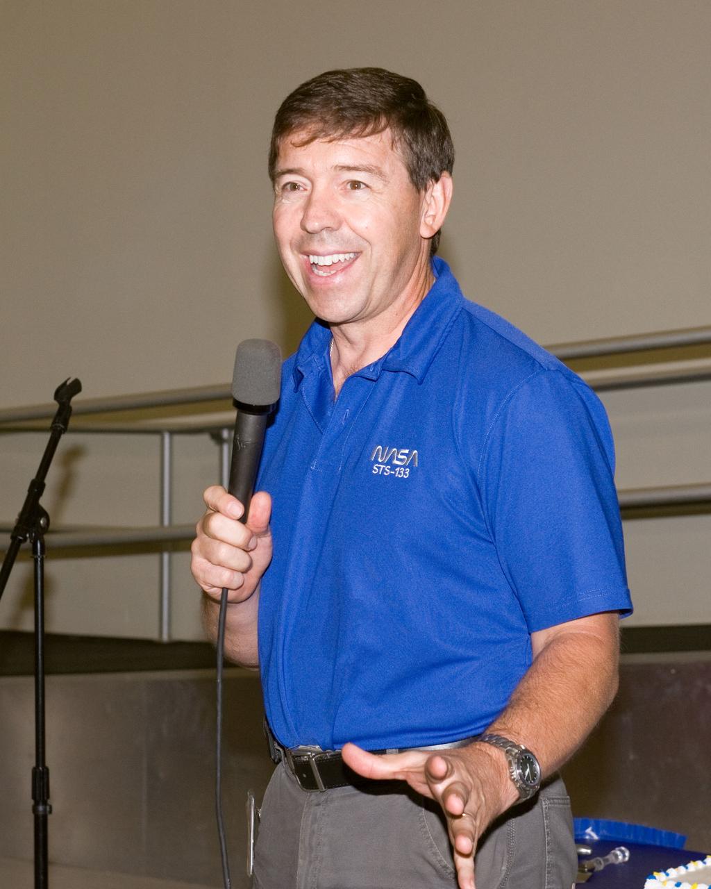 JSC2010-E-164857 (20 Sept. 2010) --- NASA astronaut Michael Barratt, STS-133 mission specialist, speaks to a crowd during a cake-cutting ceremony in the Jake Garn Simulation and Training Facility at NASA's Johnson Space Center. Photo credit: NASA or National Aeronautics and Space Administration